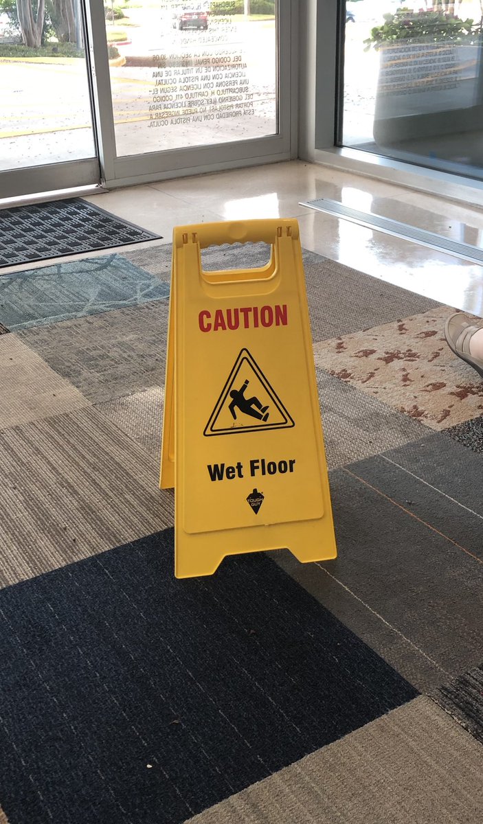 A wet floor sign on a carpet and it’s not even wet among other things here.