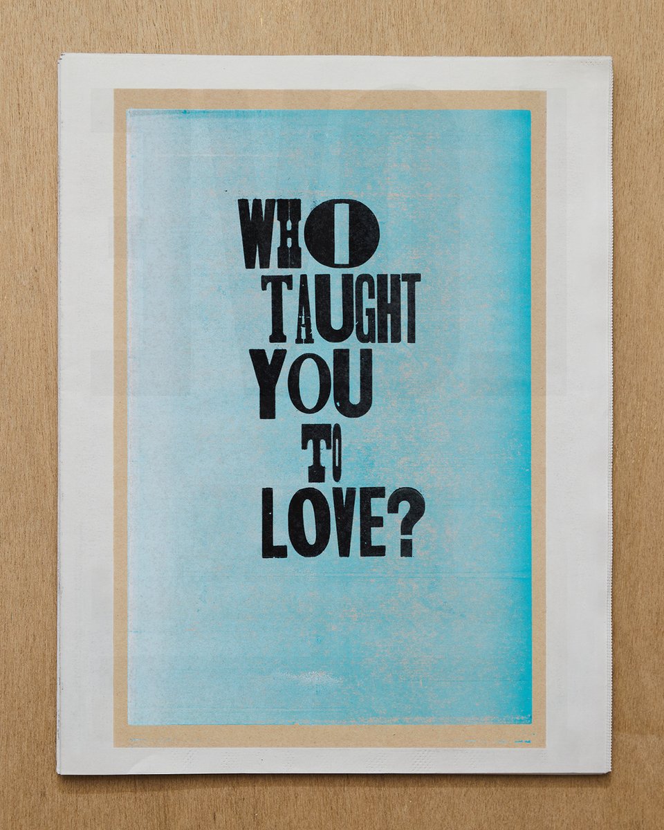 [image description: photographs of tabloid newspaper spreads on a wooden surface taken from directly above.]