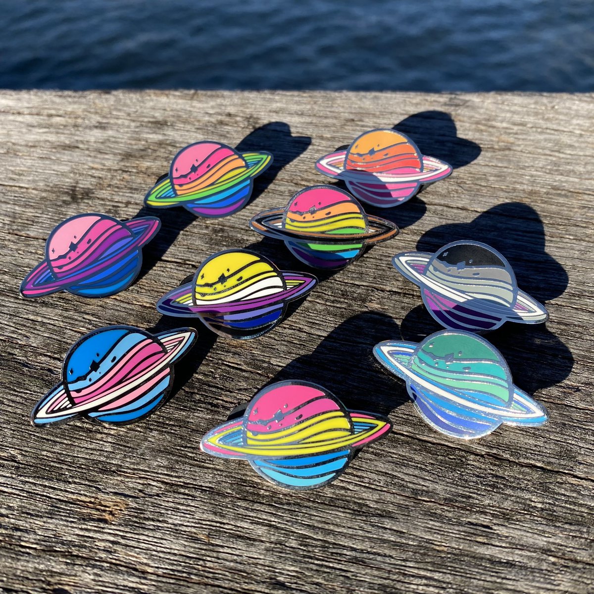 Olovia's tweet photo. Good news! It’s Pride Month, and space CONTINUES to be gay!!! All three space pride pins 🪐🚀🌙☄️ are back in stock in my store, use code SPACEISGAY for 15% off orders of three or more!! 💖🌈✨ BE GAY DO SPACE https://t.co/KK8nxmWzna