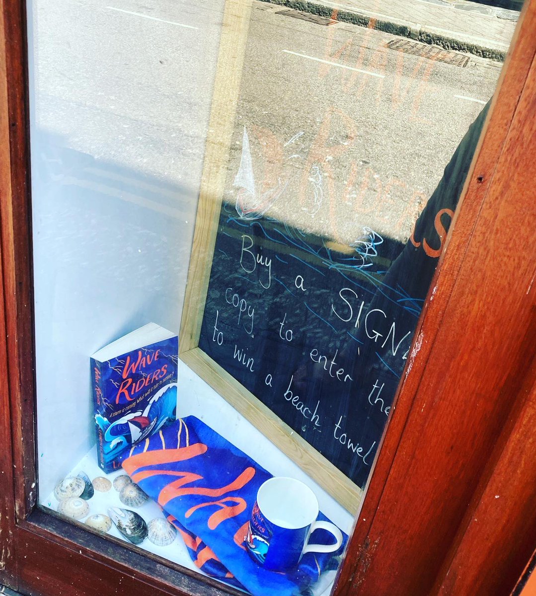 Wave Riders by @laurenstjohn in the window. Buy a signed copy to be in with a chance of winning a special beach towel and mug!!!