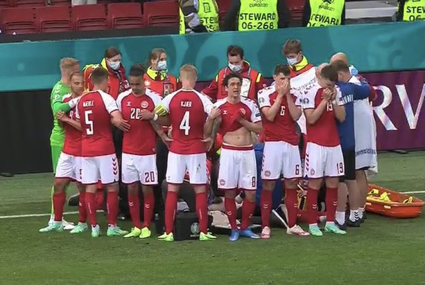 Denmark player Christian Eriksen collapses during the match with Finland. His teammates form a shield as medics try to resuscitate him. Match has been suspended.

#DENFIN