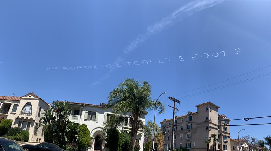 Someone just spent thousands of dollars to write “Joe Rogan is literally 5 foot 3” in the skies of Los Angeles and honestly money well spent.