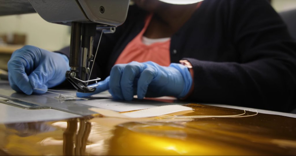 Thermal blanket technician Paula Cain uses the sewing machine in the "blanket shop" at NASA's Goddard Space Flight Center.