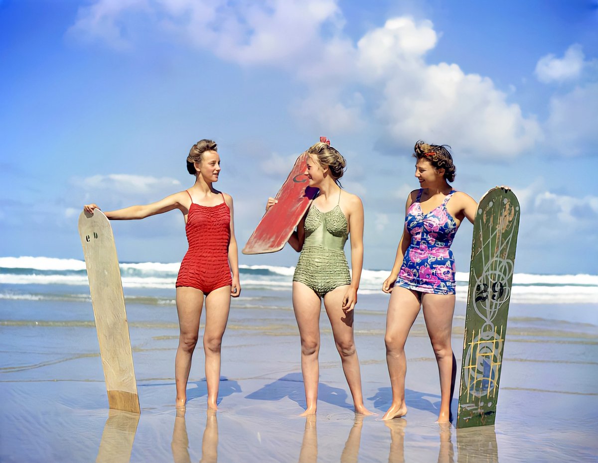Newquay surfing 78 years ago: This fantastic photo of three British munitions workers taking a surfboarding break from the rigours of their war-work, at the Cornish coast in September 1943. It is original colour, not colourised.