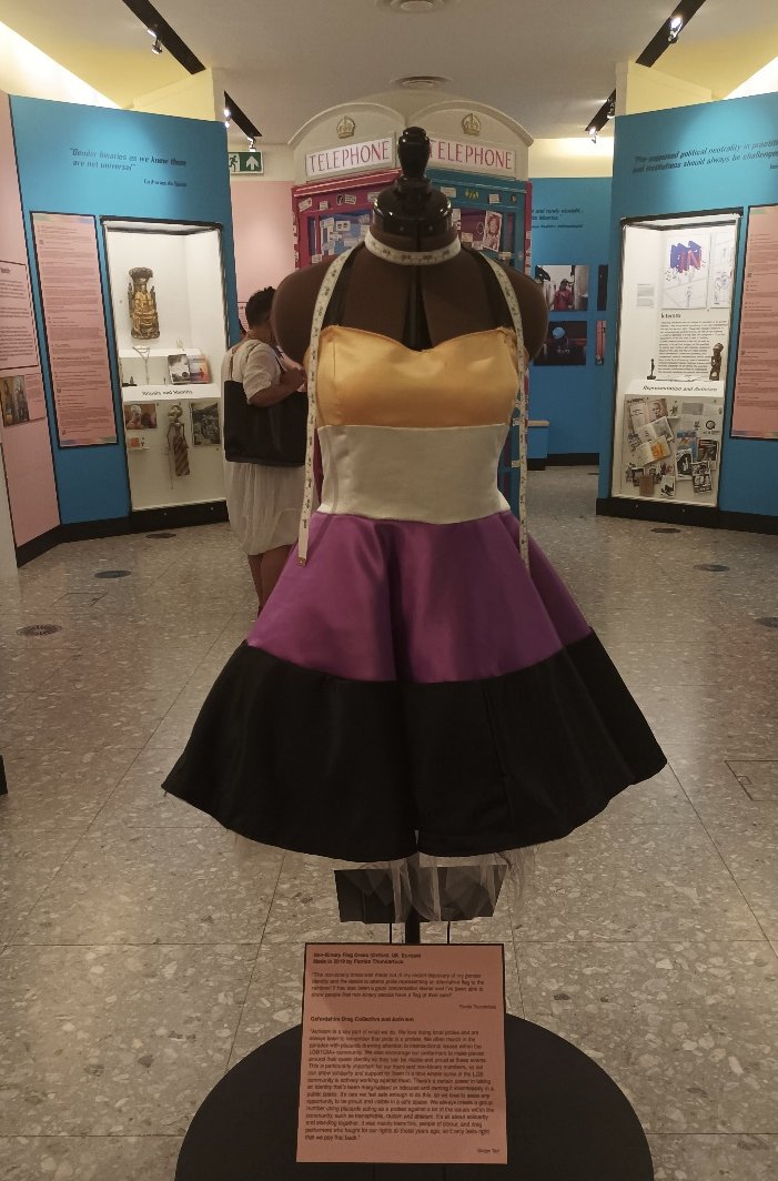 QueerBritain's tweet photo. "The non-binary flag dress made by Florida Thunderfuck in 2019 was made from their discovery of their gender identity, and desire to represent a different flag to the rainbow at Pride." 💛🤍💜🖤 #QBTakeover https://t.co/VW17GR4S3s