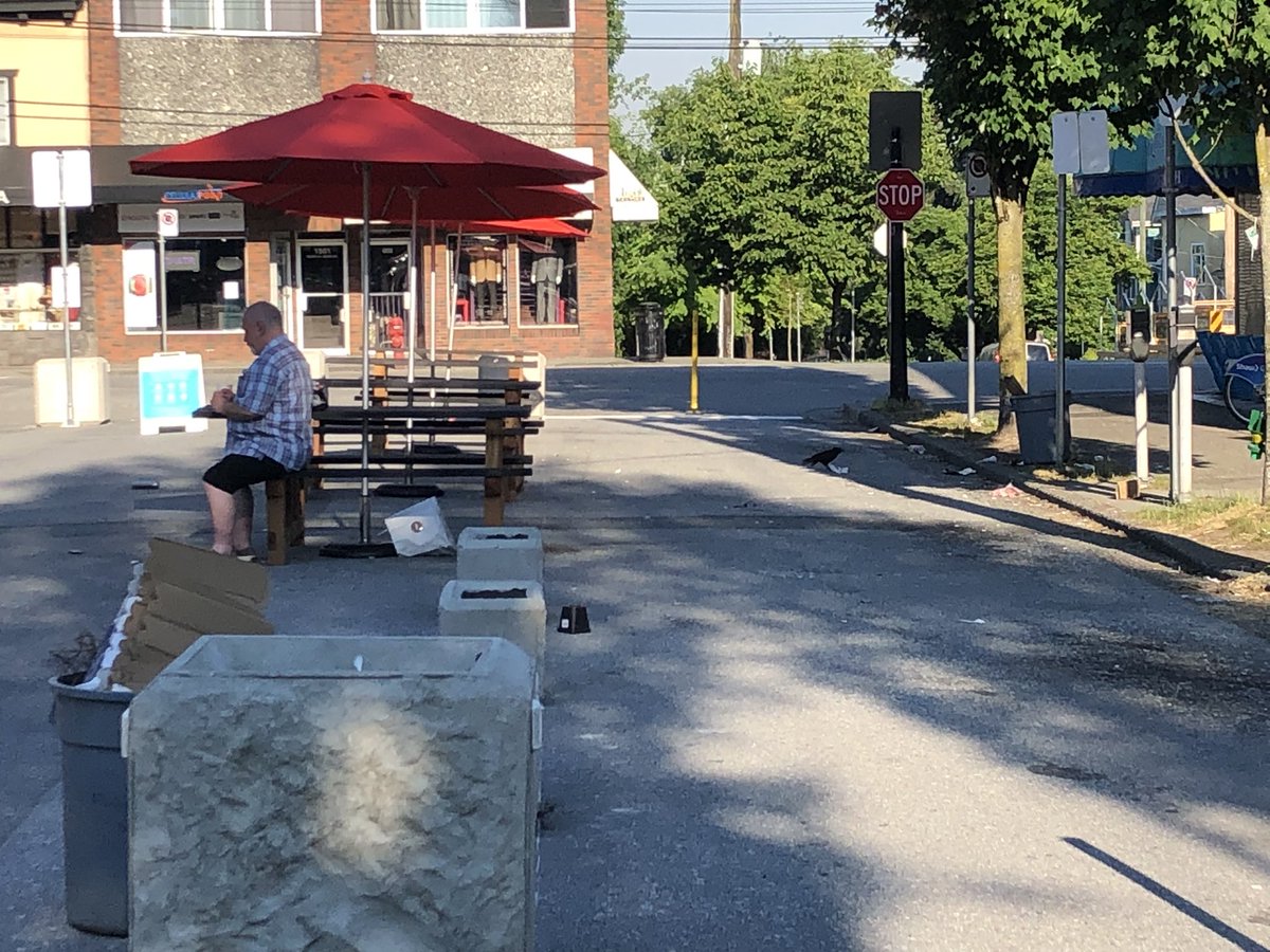 eastvanista's tweet photo. The #popupplazas at the end of my block on Grant St. at @Commerciald is an embarrassment. Where’s the garbage/recycling/compost station? water station? Proper shade? Washrooms? Or aesthetic style? I’m all for public spaces but a few picnic tables on hot asphalt doesn’t cut it. https://t.co/TTZhN0OILa
