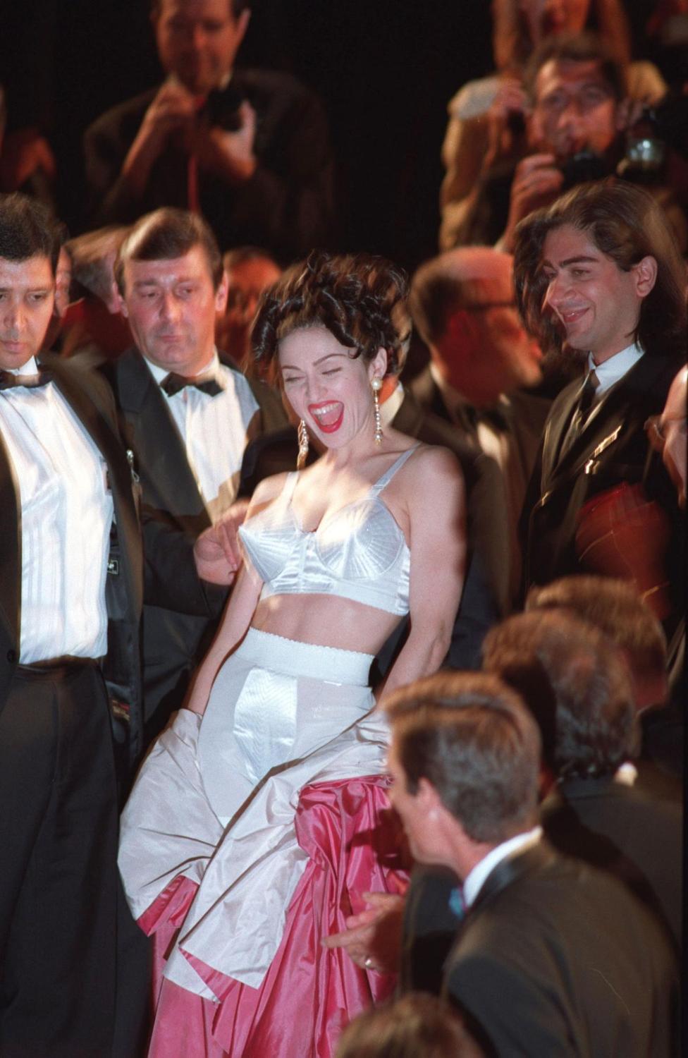 Vogue France on X: Red carpet rule breaker 💥 At the Cannes Film Festival  in 1991 Madonna wore a long pink robe. As she climbed the steps, she  stripped it off to