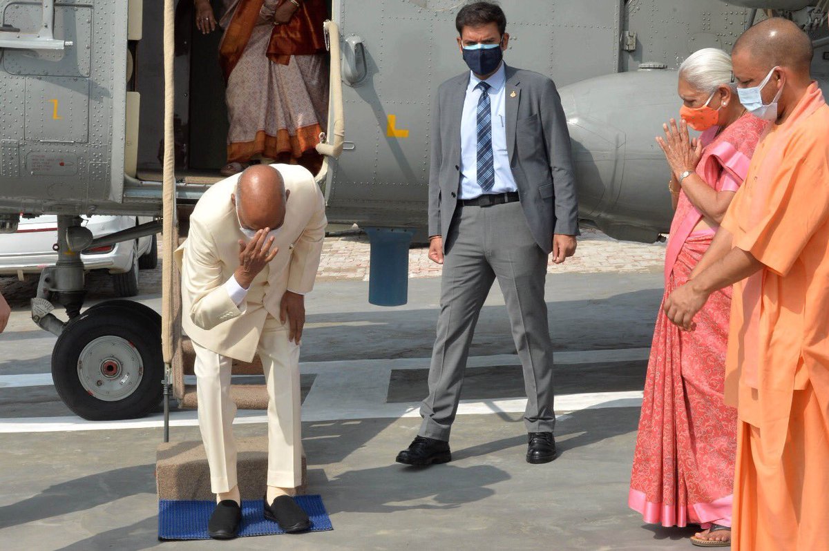 DailyNewsAssam's tweet photo. In a rare emotional gesture, after landing at the helipad near his village, Paraunkh of Kanpur Dehat district of Uttar Pradesh, President Ram Nath Kovind bowed and touched the soil to pay obeisance to the land of his birth: Rashtrapati Bhavan https://t.co/gJ7tdyztJF