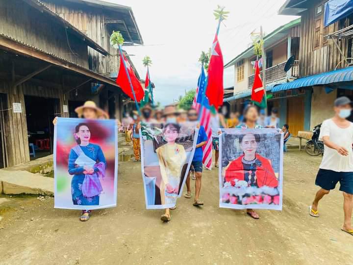 Residents from Tamakhan, Hpakant Township holding banners of our leader Daw Aung San Su Kyi’s photo and protest against military dictatorship on June 27. #RecognizeNUG #WhatsHappeningInMyanmar #June27Coup