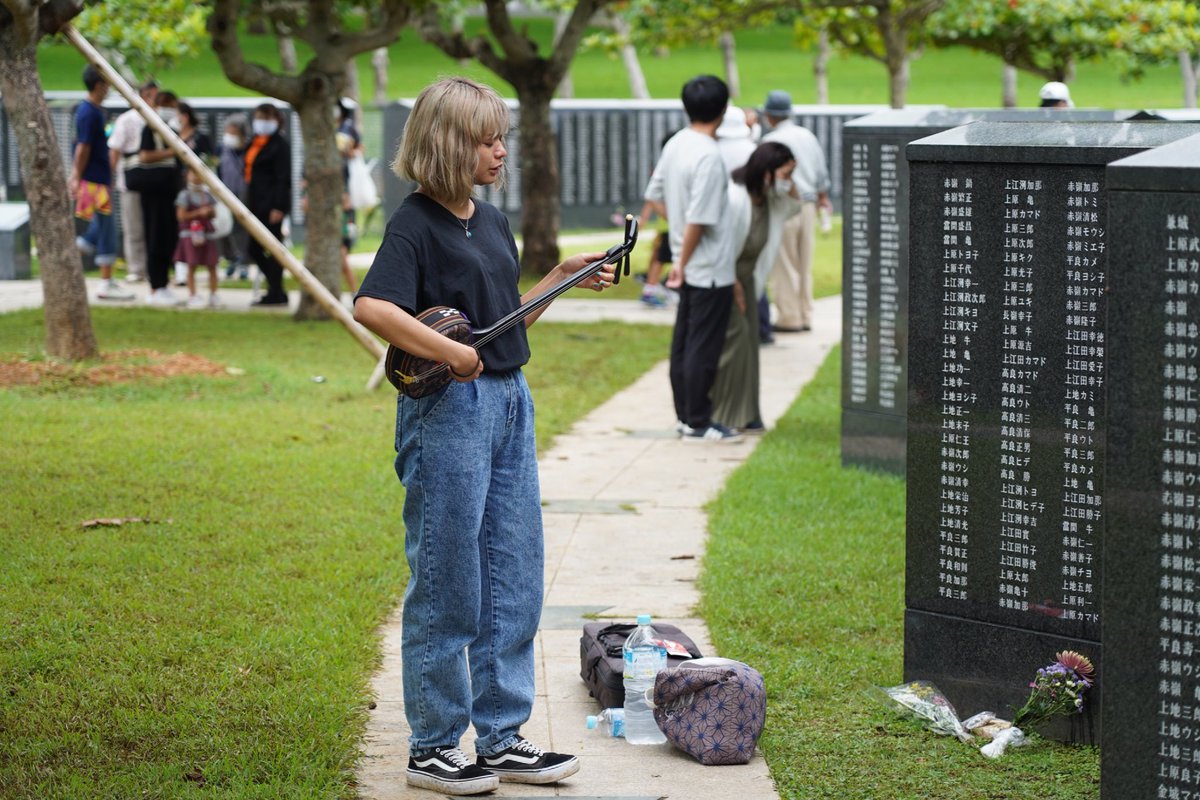 masahiroleej's tweet photo. A woman plays the sanshin at the monument "Cornerstone of Peace" remembering the victims of the Battle of Okinawa, on June 23, 2021 in Itoman, Okinawa.

📷Jinhee Lee https://t.co/7mMs9v5XA3