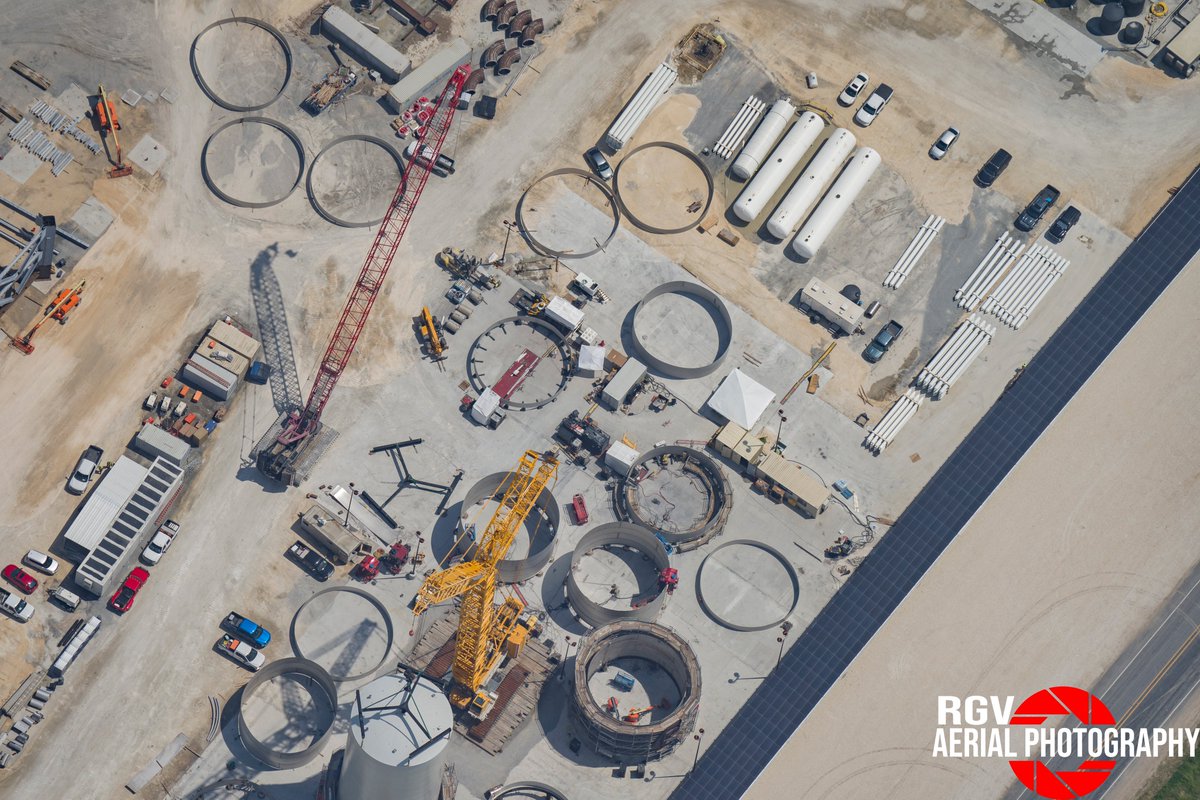 Ring sections of Starships, Boosters, and Cryoshells lay partially assembled in the Sanchez Site at Starbase.