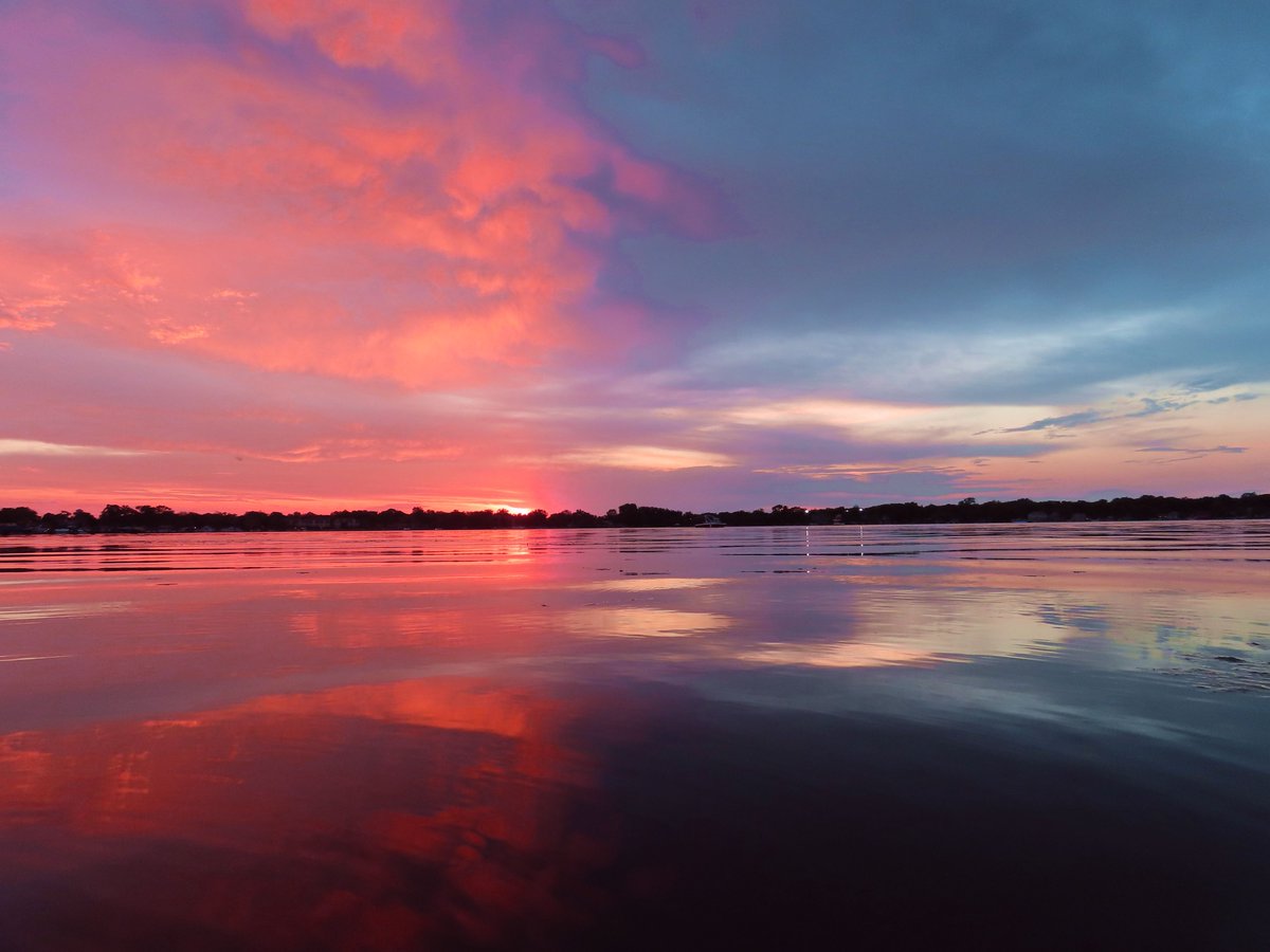 A rare 50/50 Sunset caused by a wall of clouds on the horizon near the setting sun. For more images please visit johncbader.zenfolio.com