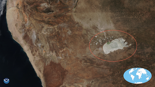 NOAA-20 image of the northwestern corner of Namibia, with the Etosha salt pan circled in red, 6/15/21. An inset globe highligths the area in a red box. 