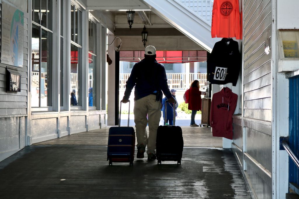 MackinacGuide's tweet photo. When you get off the ferry a porter will transport your luggage to your hotel. Be sure to tip them. They work hard rain or shine. #mackinacisland #makeitmackianc #visitmackinac https://t.co/eQBKnI9rW3