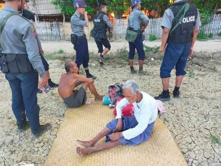 The photo showsmembers of security forces looking after n protecting elderly people from Kinma village in Pauk township Tuesday after rescuing them from the village-fire which PDF militants torched despite knowing that the old people from the village could not escape it.