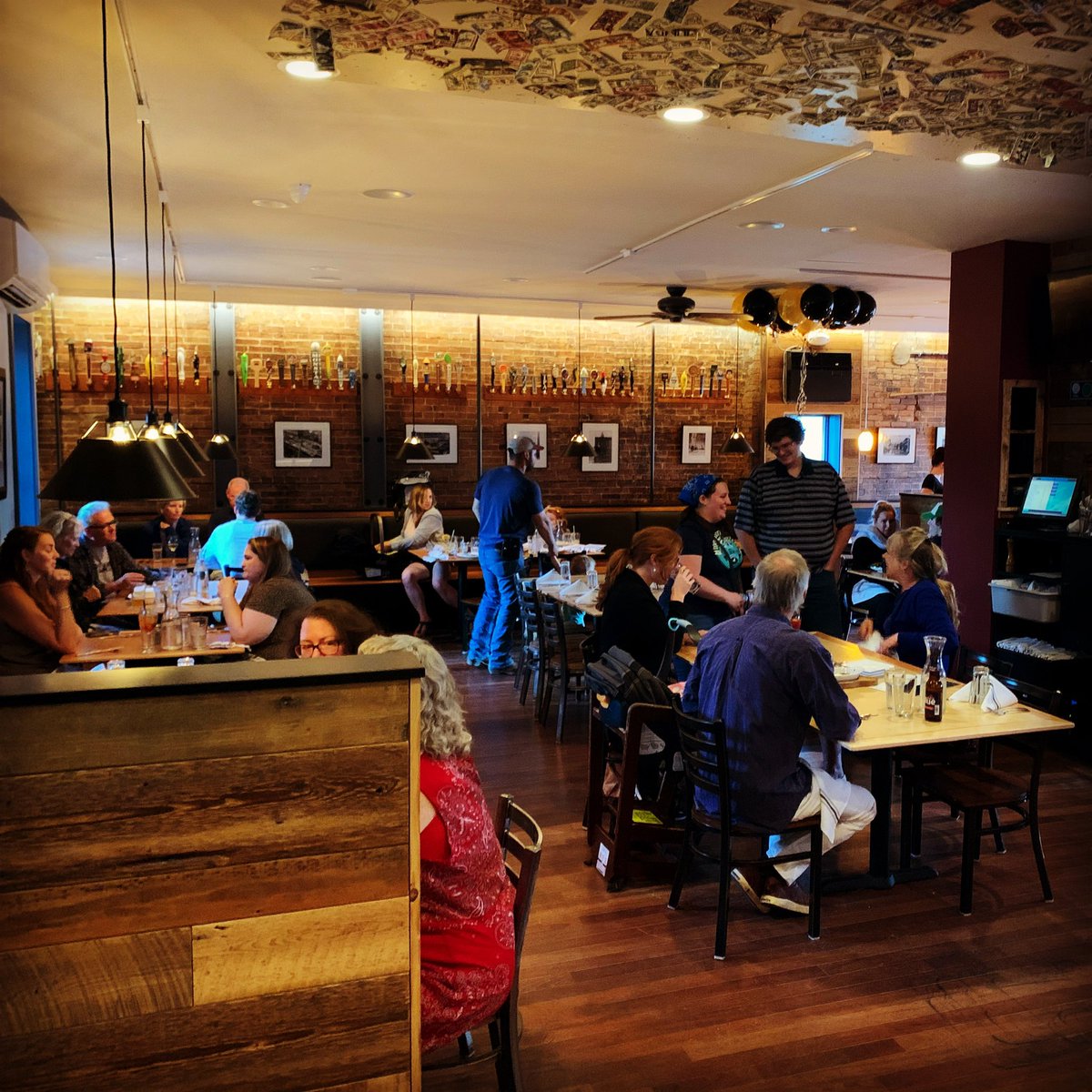 TwoBrothersTav's tweet photo. The Tavern is back! We reopened in our newly-renovated space last night (with an updated menu for summer!). What a joy it was to see people in it! We’re going to need to decorate with some more dollar bills, though…the new section of the ceiling is looking a little bare! 😉 https://t.co/PeXM2n5YiG