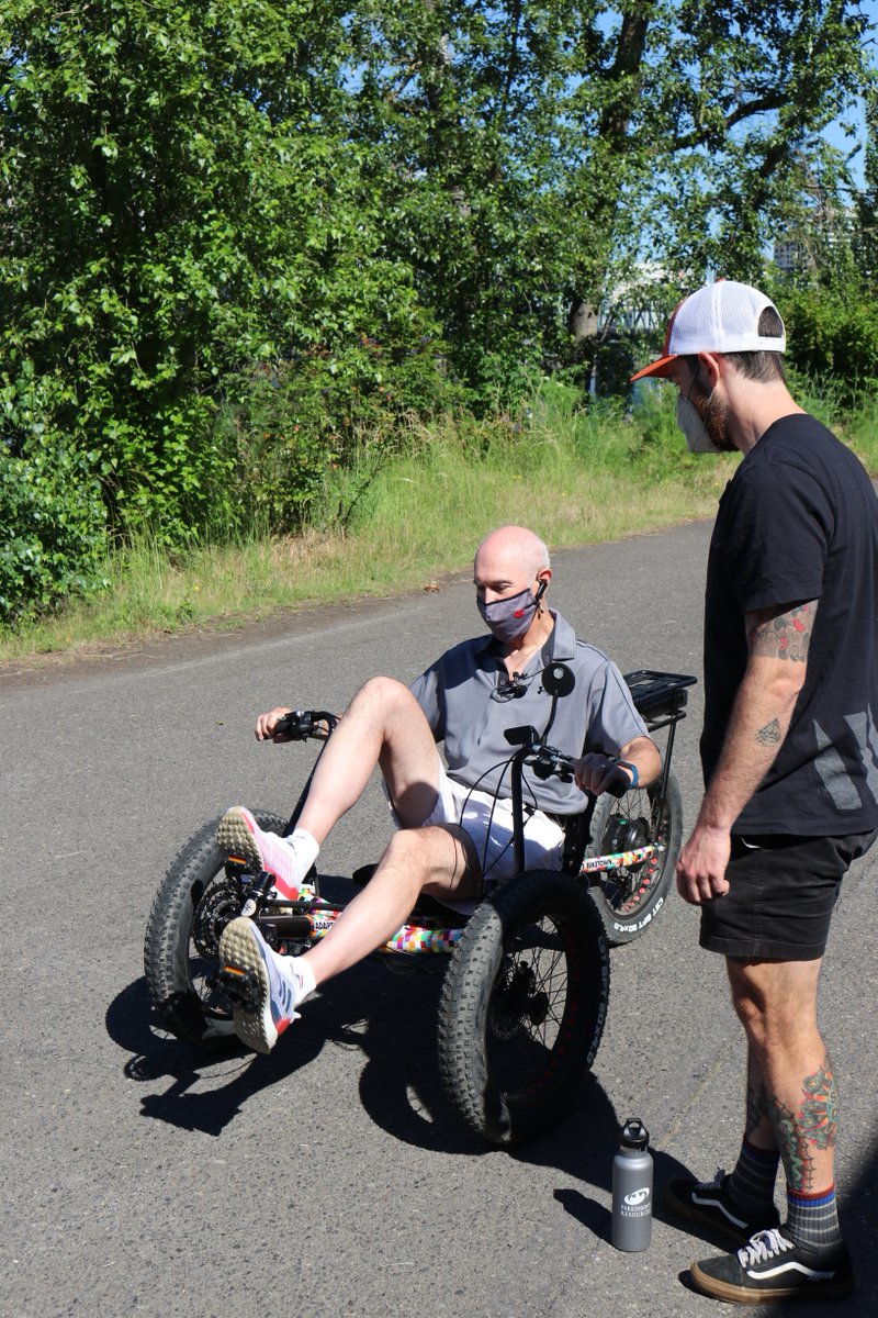 PBOTinfo's tweet photo. We were excited to join folks from @pdpronw today while they gave Adaptive BIKETOWN bikes a try! Here, Christopher Redmond, who's living with Parkinson’s, gets fitted to a recumbent tricycle with electric assist, and Carol Clupny, also living with Parkinson’s, test rides a trike. https://t.co/wExUaX71Vc