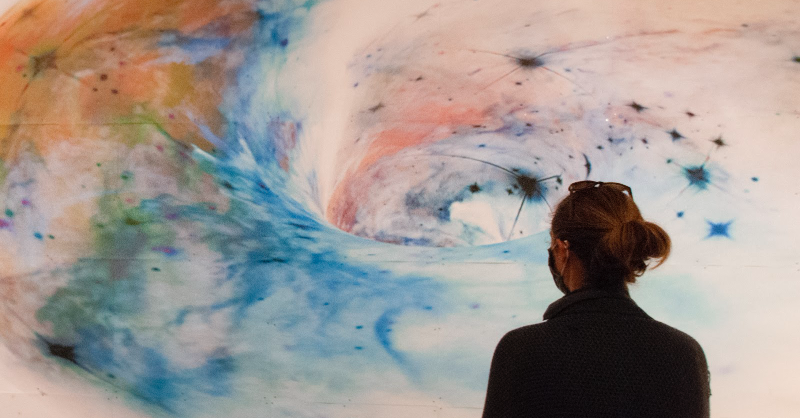 SDMA's tweet photo. This huge galaxy #drawing is one of 2! 💫
Here, our Assistant #Registrar closely examines the condition of each paper panel before handing them off to our Chief #Preparator and #MuseumTechnician for #installation—using magnets and a carefully laid out grid on our #gallery wall.