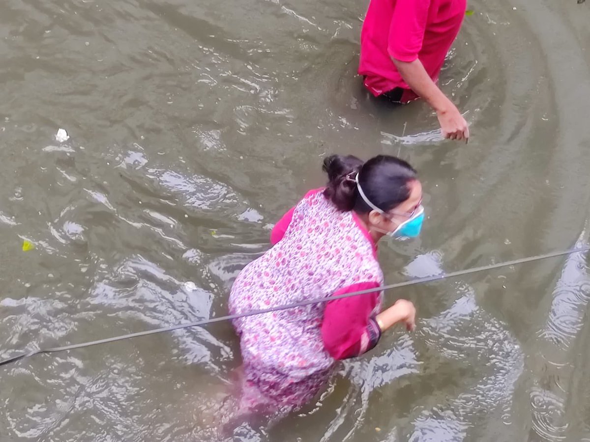 iamadityaghosh's tweet photo. All superheroes don’t wear capes but here is one who has been a hero to me all my life - my sister Dr Chandrima Ganguli | here she is wading through waist deep water yesterday in #Kolkata on her way to the hospital to go save lives. just another day at work for Didi! #Inspiration https://t.co/hfpIO3zK3m
