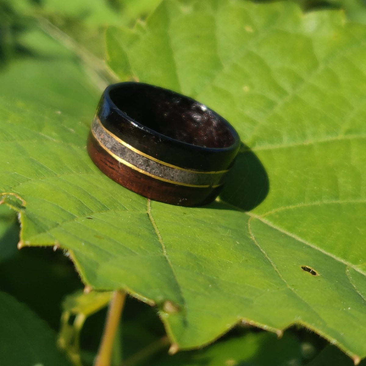 bentwoodforge's tweet photo. First time ever working with gold wire for an inlay. Not sure why, but working with it made me really nervous, but I sure love me a challenge. The stone is crushed sapphire and the wood is macassar ebony. https://t.co/QsPCnORW1r