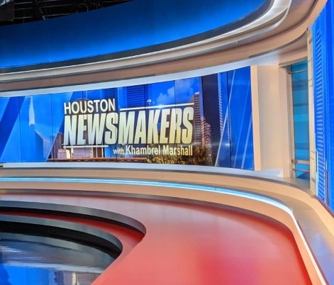 a broadcast news studio wall with a Houston newsmakers display on the wall