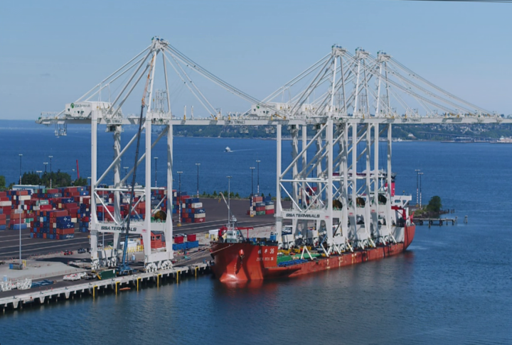 Four massive cranes arrived in Seattle by boat that will be set up on Terminal 5 at the Port of Seattle. The first has been moved off the boat, with 3 to go. The cranes are 316 feet tall and extend 240 feet over the water. How do they get off the boat, they roll, very slowly.