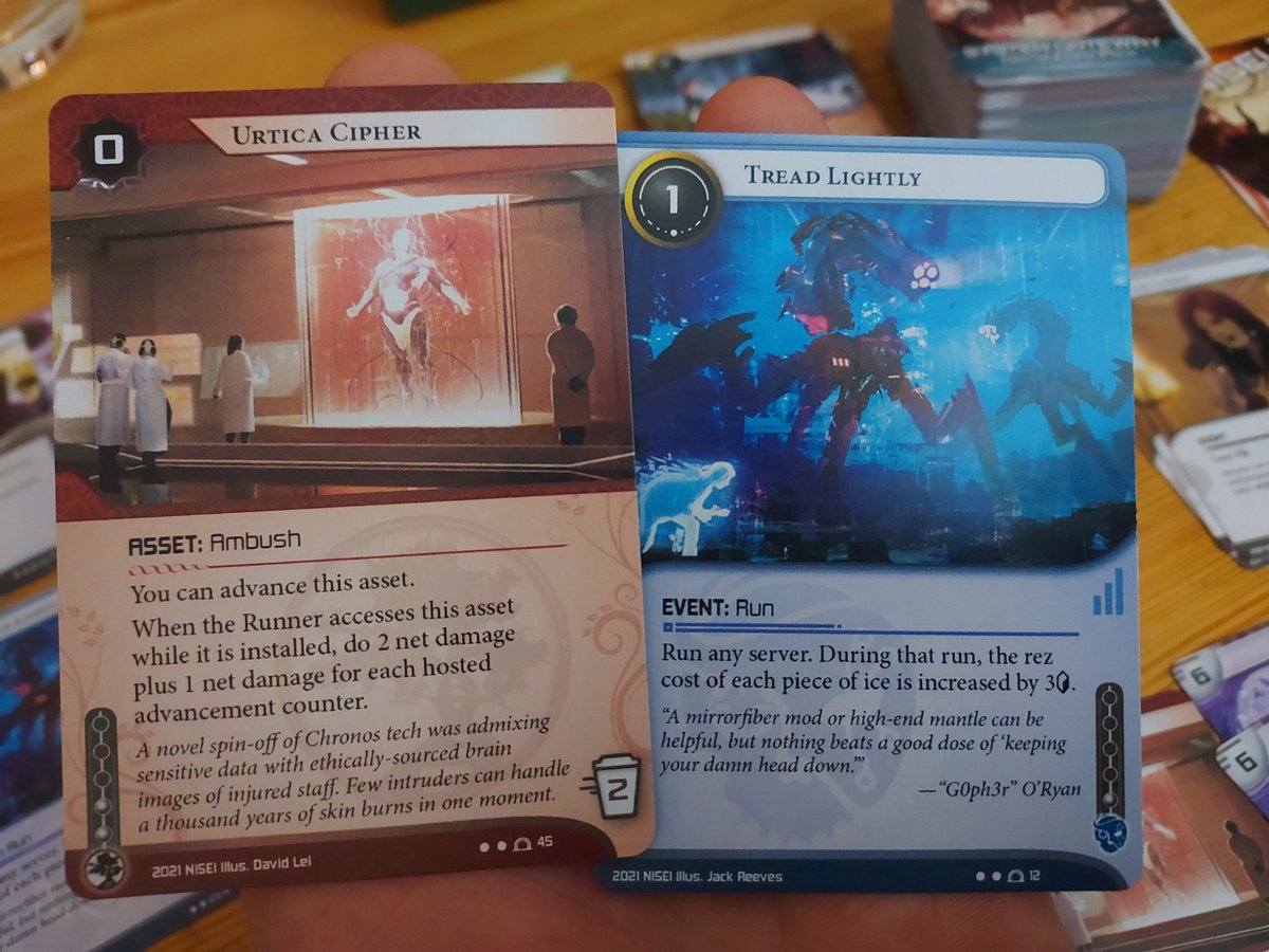 A photo of two netrunnner cards: urtica cypher and tread lightly