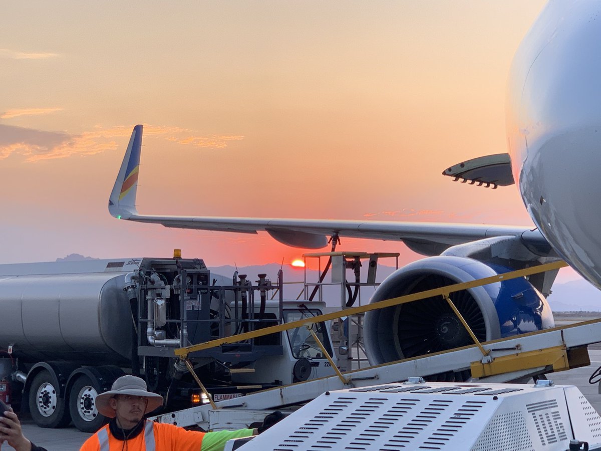 TysonOnTV's tweet image. The sun rises an angry red as seen from @gatewayairport. Air attack planes on the tarmac ahead of what will be a critical day in the firefight against the #BackboneFire