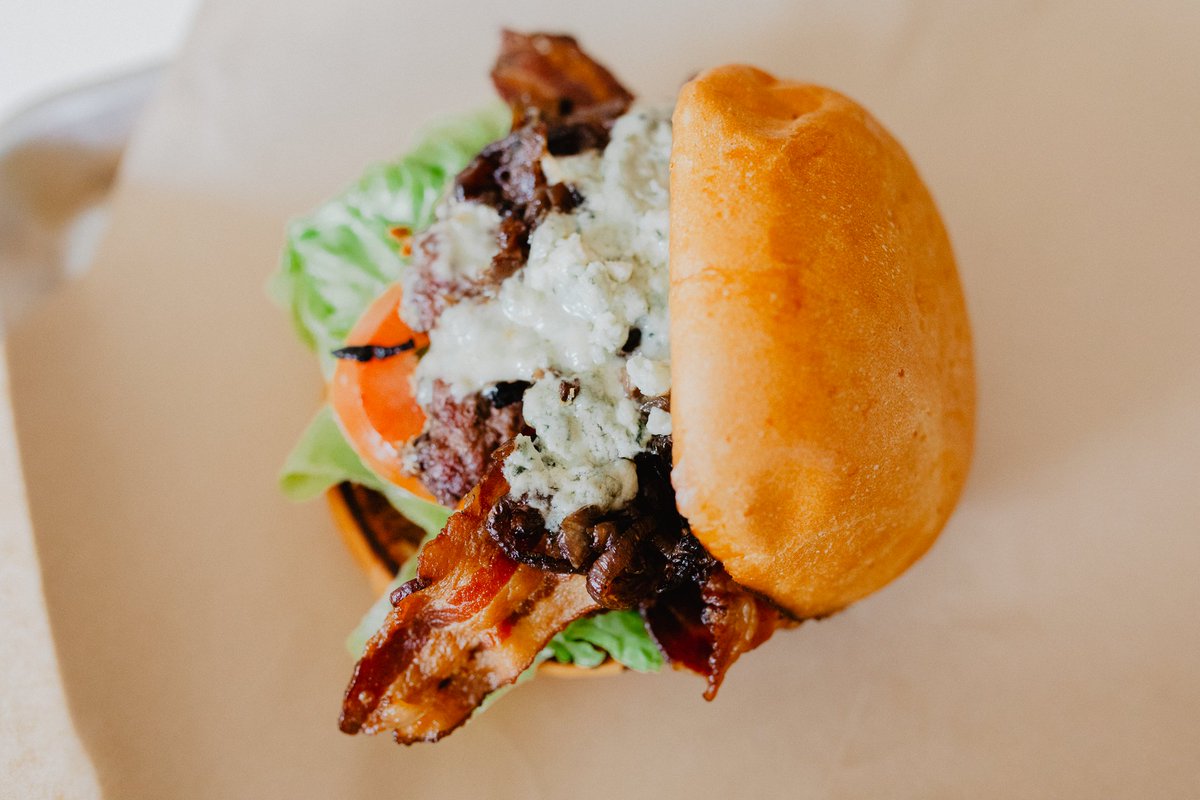 BACON &amp; BLUE
local Colorado beef topped with bacon, blue cheese, caramelized onion, lettuce, tomato, &amp; house sauce on a potato bun