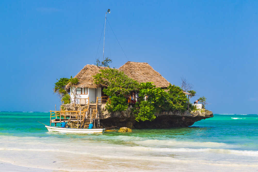 Tembeliaa's tweet photo. The Rock Restaurant can be said to be one of the scenic restaurants in Africa. This restaurant is located on a rock in the Indian Ocean. Would you like to order for your seafood and other delicacies at the Rock Restaurant? #VisitTanzania #TheRockRestaurant #travel #tembelia https://t.co/jQd7JtmmRh