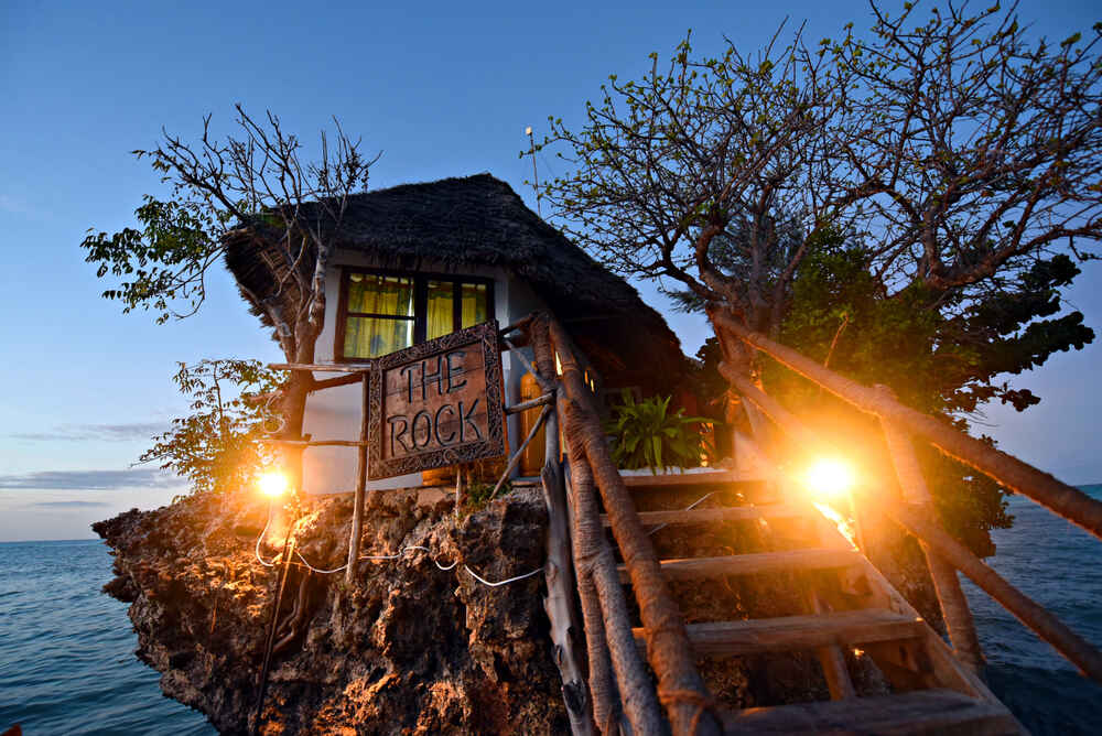 Tembeliaa's tweet photo. The Rock Restaurant can be said to be one of the scenic restaurants in Africa. This restaurant is located on a rock in the Indian Ocean. Would you like to order for your seafood and other delicacies at the Rock Restaurant? #VisitTanzania #TheRockRestaurant #travel #tembelia https://t.co/jQd7JtmmRh