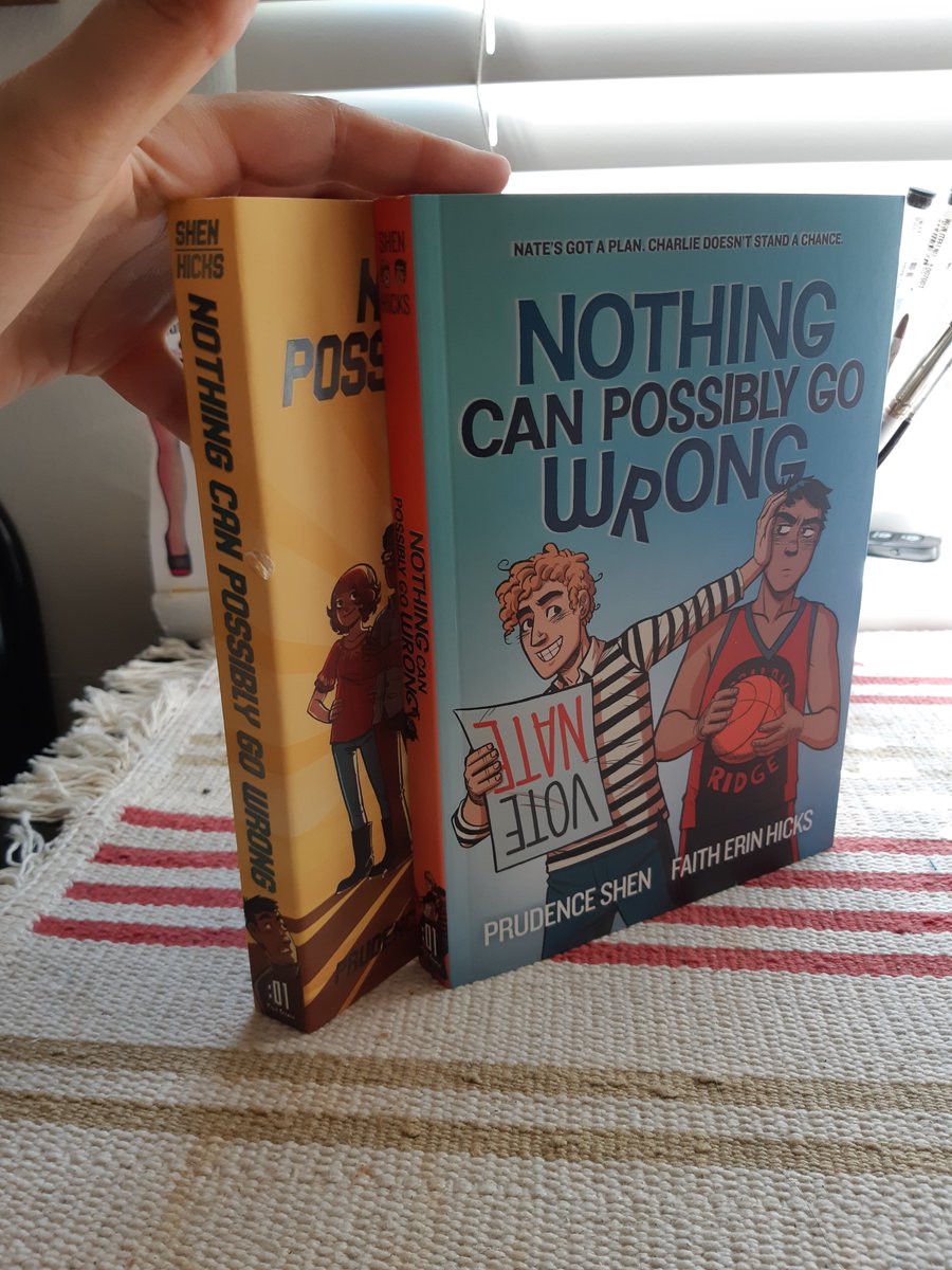 FaithErinHicks's tweet photo. Okay, I'm going to tweet about the brand new, FULL COLOUR (by Alison Acton) edition of Nothing Can Possibly Go Wrong, a young adult comic I drew and adapted from a novel by Prudence Shen! Originally it was published in 2013 in black &amp; white. Here's the 2 books together: https://t.co/HNoNTrfidN