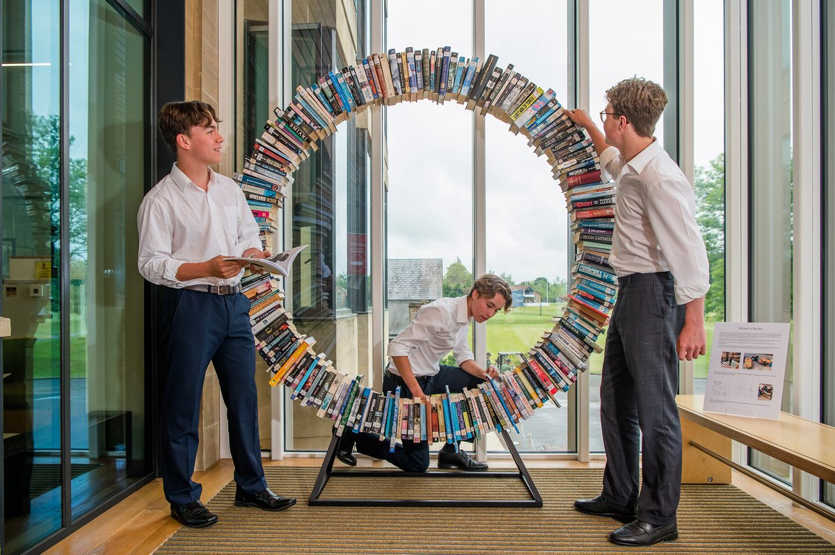 TonbridgeUK's tweet photo. A recent addition to the School's Library is this wonderful Wheel of Books, created by Will Biddle (Housemaster and DT Teacher) for the entrance way. It is nearly seven feet tall, contains 270 real books, took many months to create and is proving to be quite a talking point! 📚 https://t.co/SZhAwaMow1