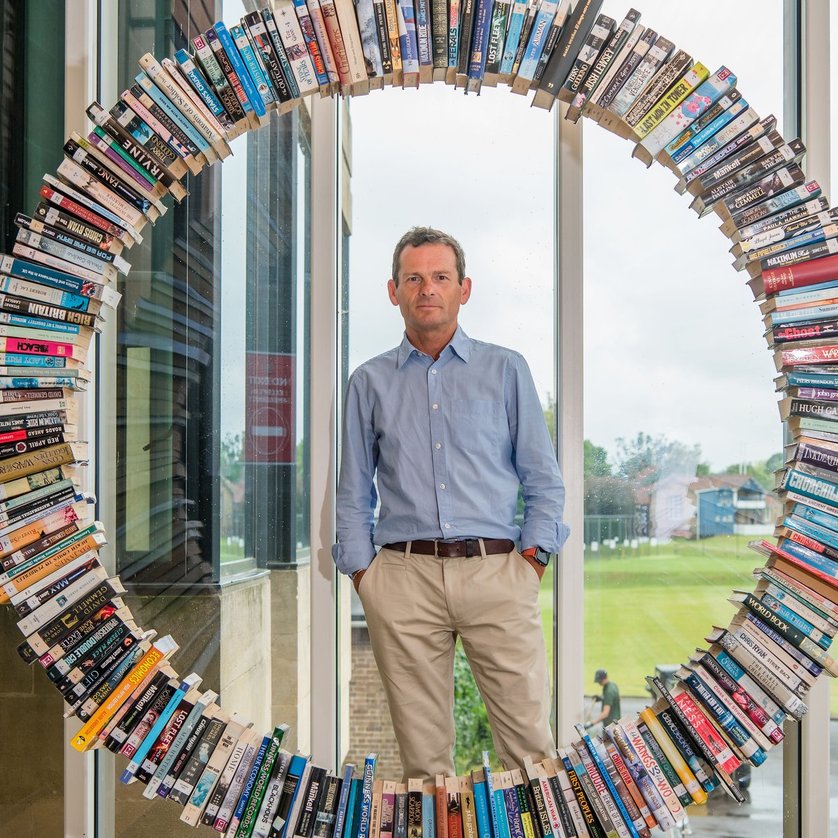 TonbridgeUK's tweet photo. A recent addition to the School's Library is this wonderful Wheel of Books, created by Will Biddle (Housemaster and DT Teacher) for the entrance way. It is nearly seven feet tall, contains 270 real books, took many months to create and is proving to be quite a talking point! 📚 https://t.co/SZhAwaMow1