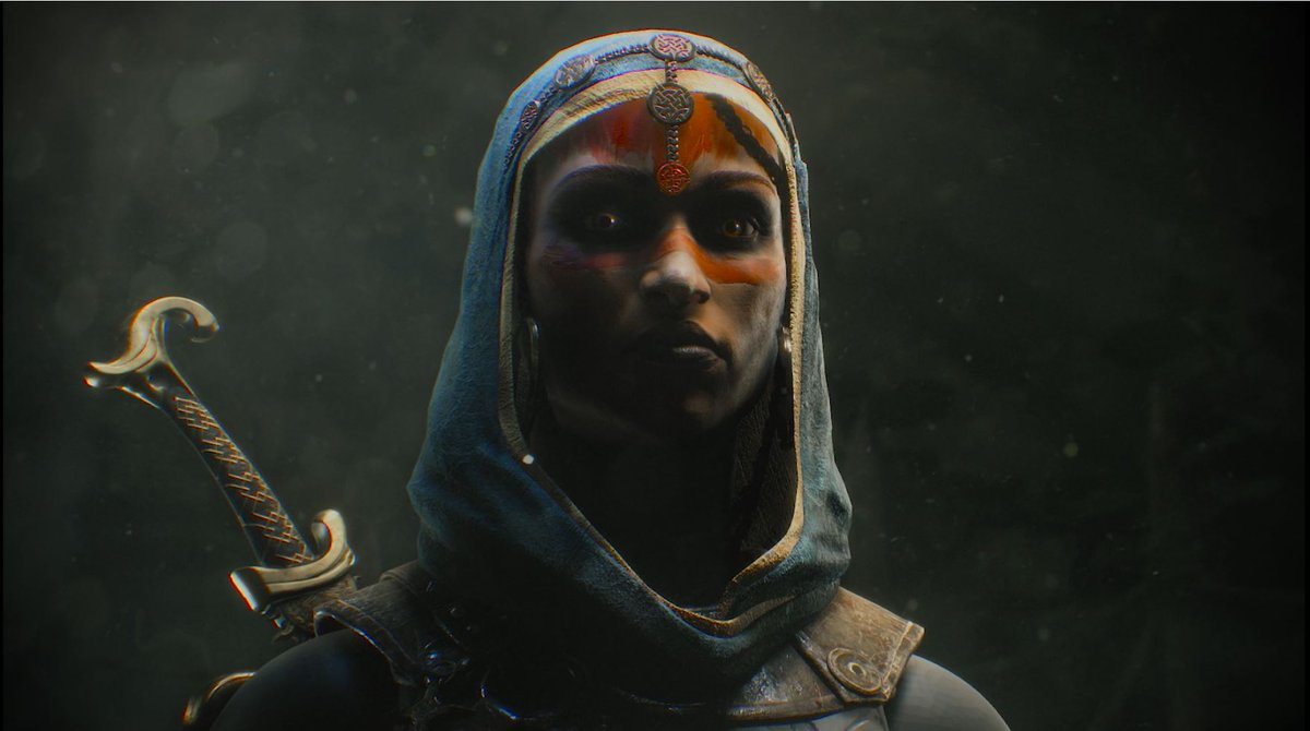 An arabic-looking women is standing, ready for battle with a sword on her back. She looks fierce and has make-up applied to her face.
