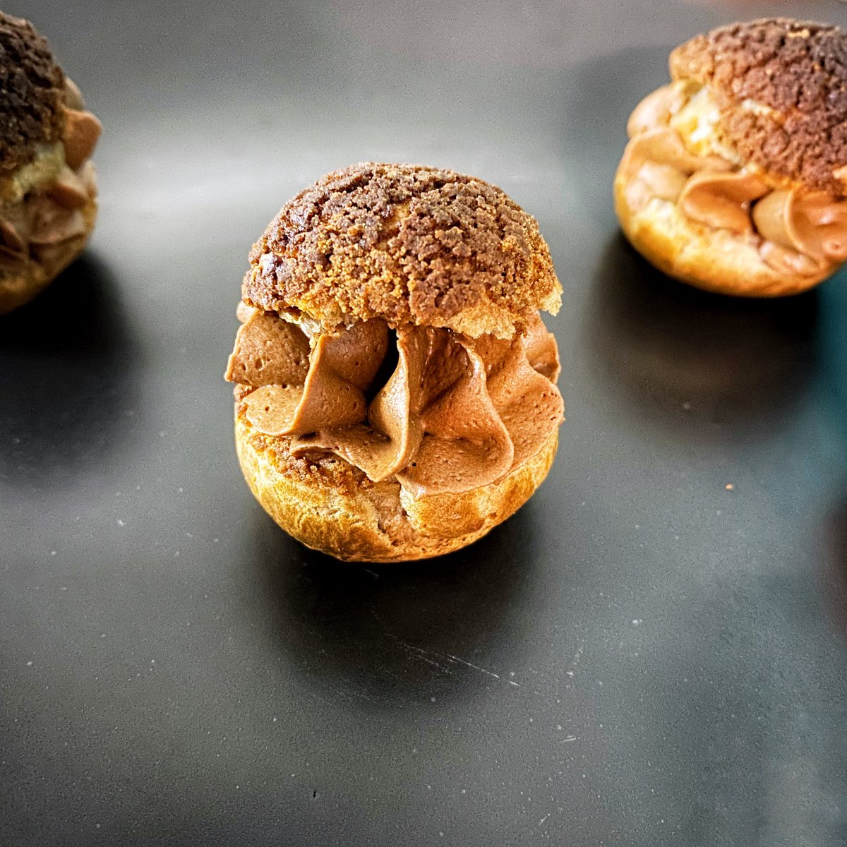shreyadeshpande's tweet photo. Mini #choux anyone? Baked choux au craquelin with a chocolate creamaux and hazelnut praline. Absolutely loved making these mini oysters of joy π€© #bake #baking #loveforbaking #bakingtherapy #chocolate #callebaut #frenchpatisserie https://t.co/EzdgvkOAyT