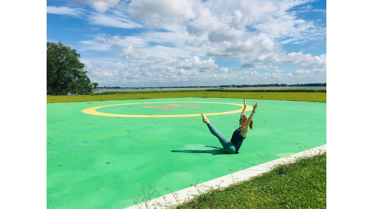 STOTT_PILATES's tweet photo. STOTT PILATES® Lead Instructor Trainer Amy has found a helicopter pad, in the Mekong Delta, to practice her #PilatesTeaser. https://t.co/d37kLVxi9G