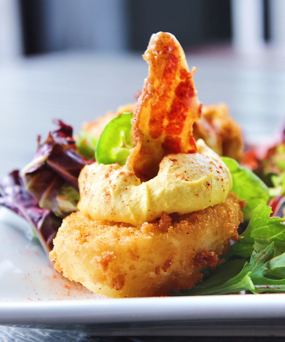 Champps's tweet image. 'Tis the season for warm weather, cool drinks and tasty food!☀️ Topped with sliced jalapeno and candied bacon, our Deep-Fried Deviled Eggs are the perfect summer snack! Available for dine-in, takeout and delivery for a limited time. 
 (📷: @cuisineandcocktails)