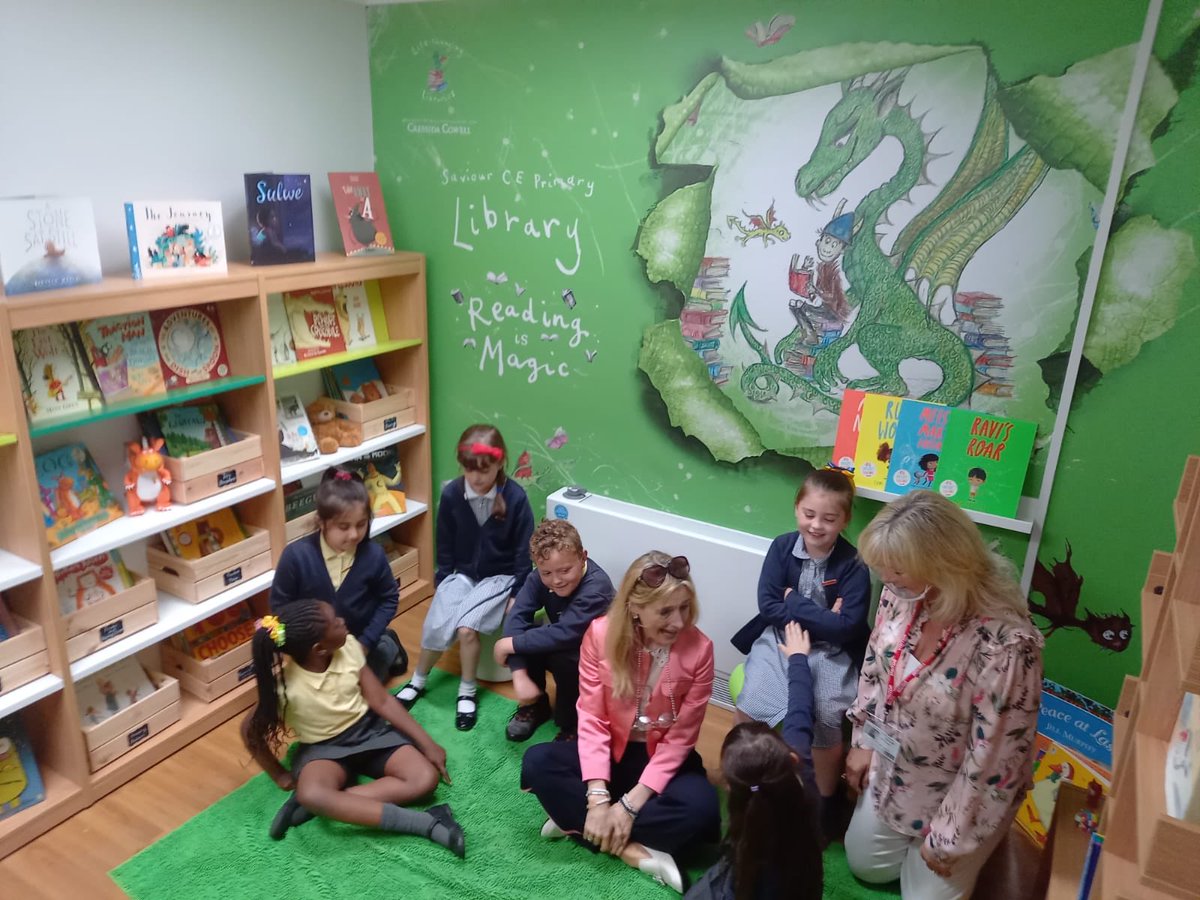 CressidaCowell's tweet image. Saviour Primary School didn’t have a big space available for a library but this shows what you can do in two smaller spaces - here I am chatting to the new and very enthusiastic Team Read Year 2 Reading Ambassadors in the new Key Stage 1 library #lifechanginglibraries