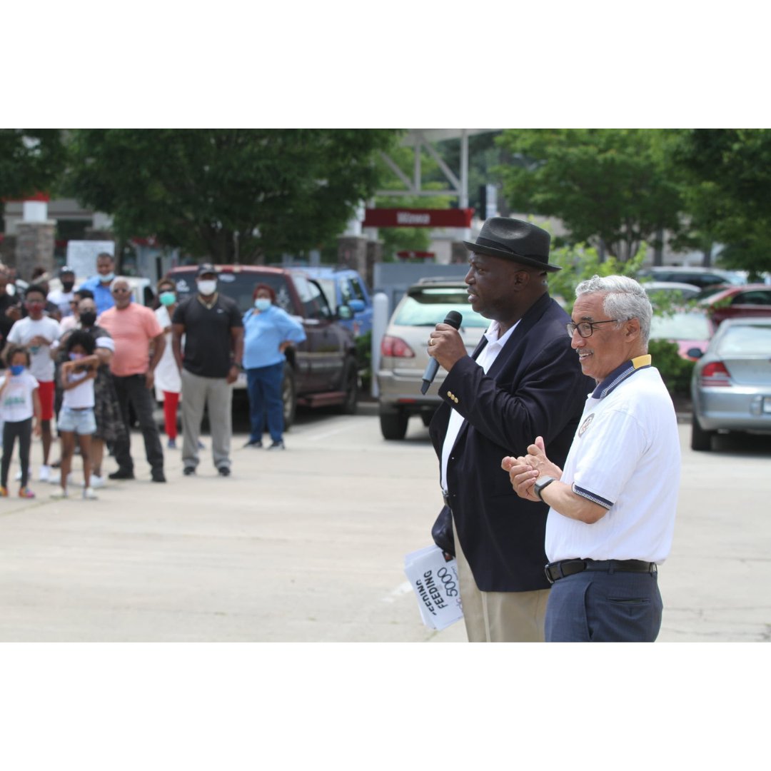 2 event organizers address a line of community members