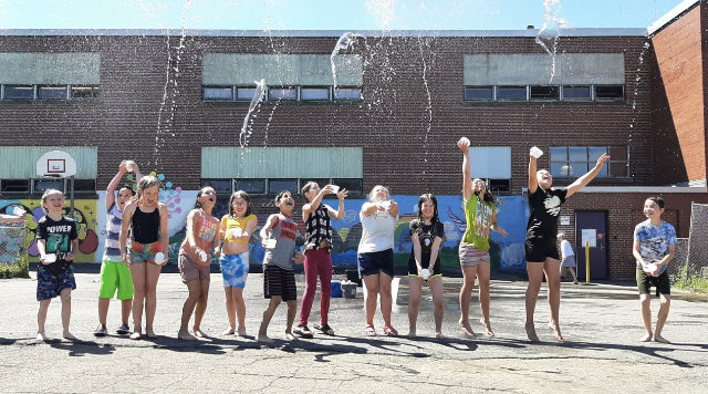 SJBKE_School's tweet photo. Ms. Hunter’s grade4 class didn’t mind getting wet in the quest to empty the bucket! Working as a team and having fun - a great way to end the day! ⁦@PALSpartners⁩ ⁦@ASD_South⁩ https://t.co/MNuLbOTgsX