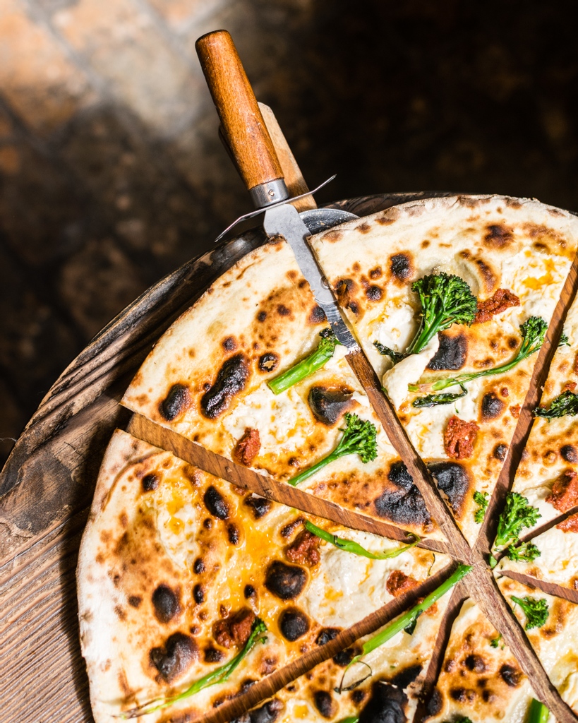 A slice of our 'Nduja pizza, topped with Tenderstem Broccoli, Fior Di Latte & Chilli Oil drizzle... and all is right in the world. It's pizza, but not like you've had it before.