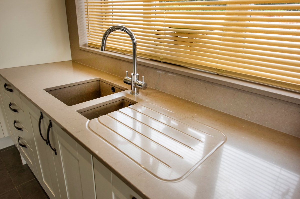 These professionally taken pictures, perfectly capture the high level of quality our team aims to ensure. Our fitters have helped bring to life a simple yet sophisticated kitchen design, with surface wide upstands joining the window sill and a modern hob cut-out.