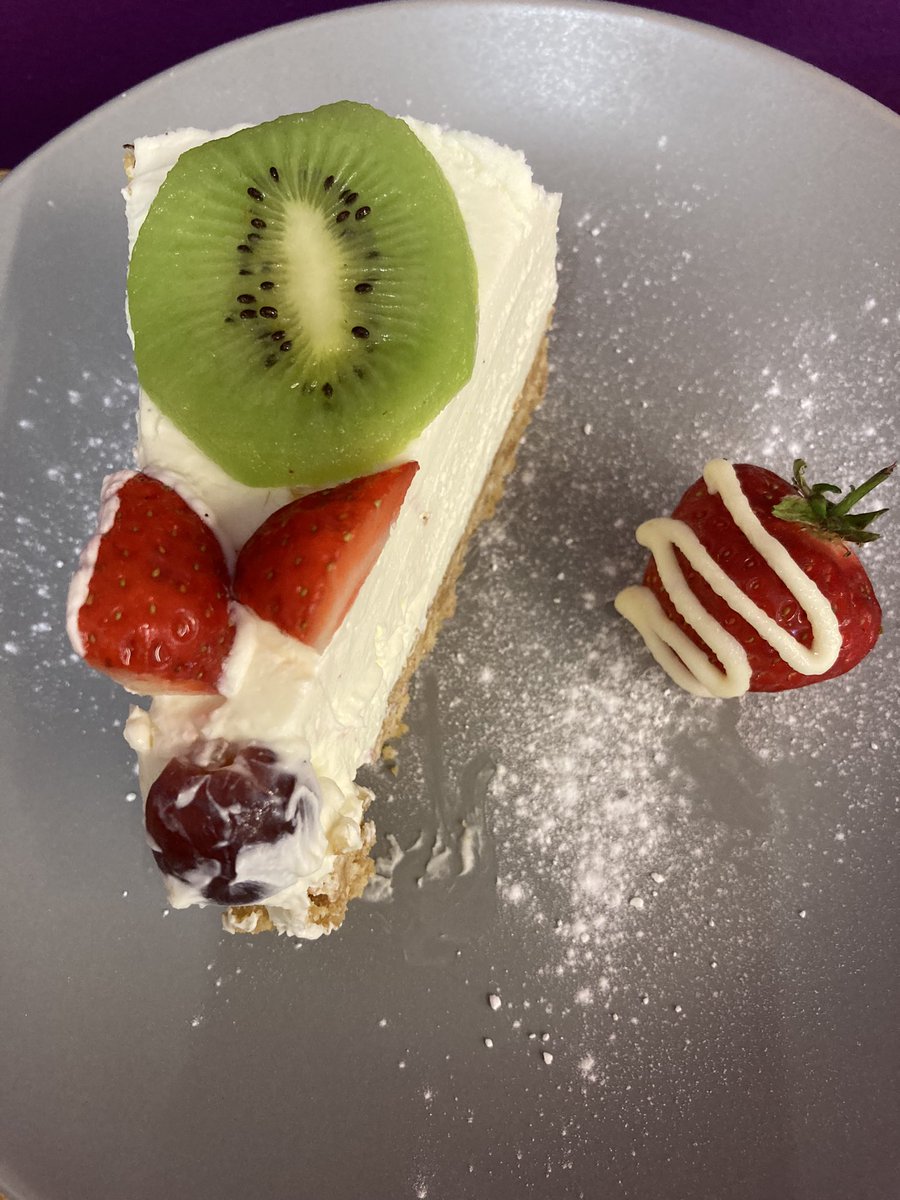 Vanilla cheesecake with a fruit topping and chocolate covered strawberry on the side. Freshly baked and only £1.95 a slice. #homemade #coffeshop