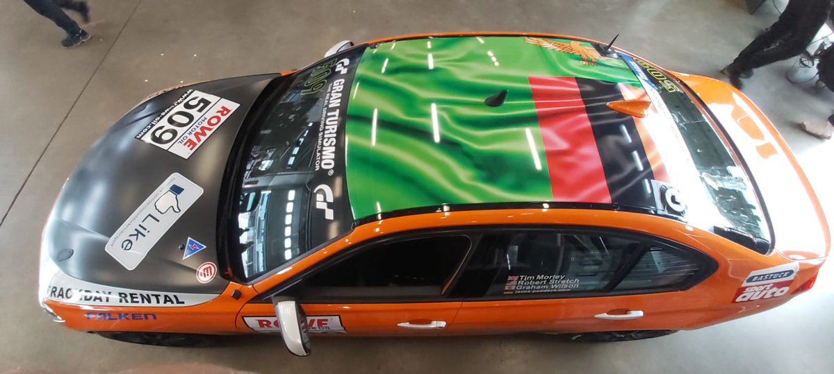 A_Higgins's tweet image. Why is there a Zambian flag on the roof of a racing car in Germany?? Because we do the marketing and website for @JacosPaddock. All their race cars have flags on the roof and they thought it would be cool to do the Zambian flag as a surprise for us on their newest BMW F30 car!