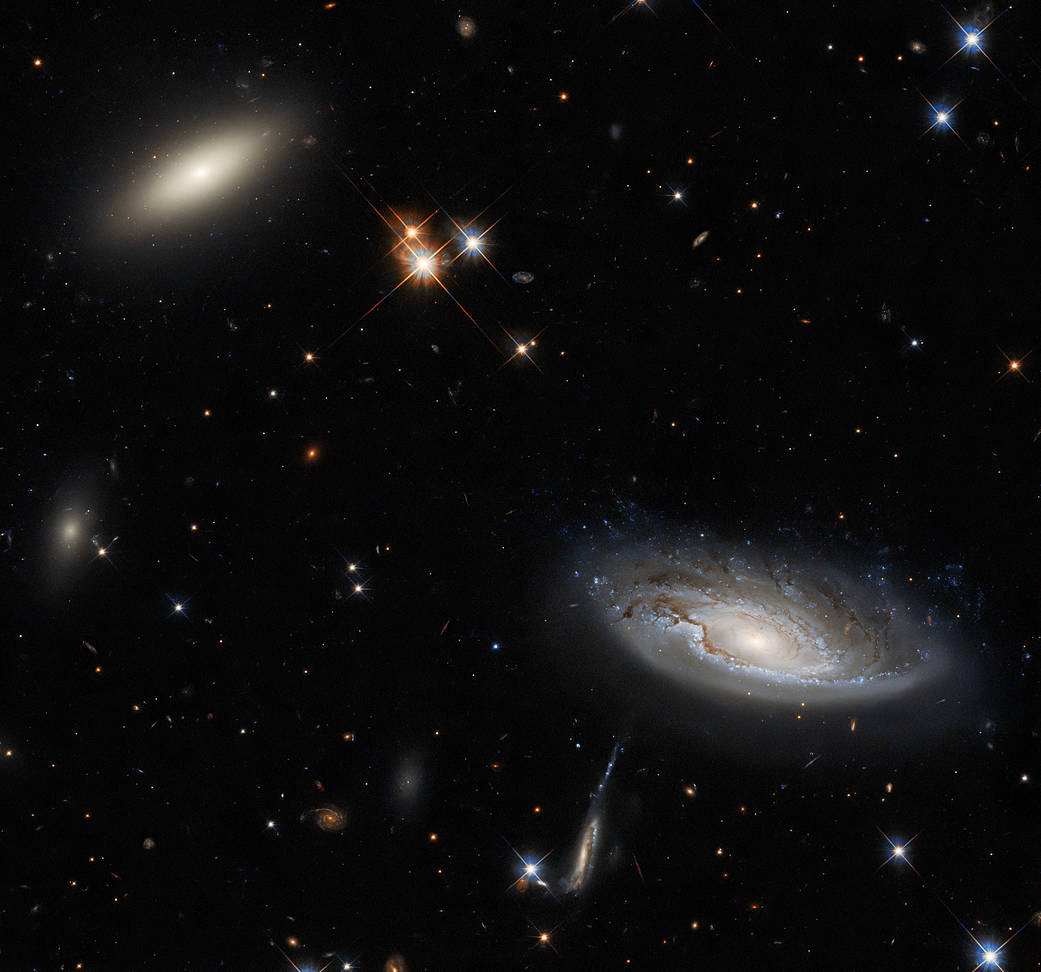 Two enormous galaxies capture your attention in this spectacular image taken with the NASA/ESA Hubble Space Telescope using the Wide Field Camera 3 (WFC3).