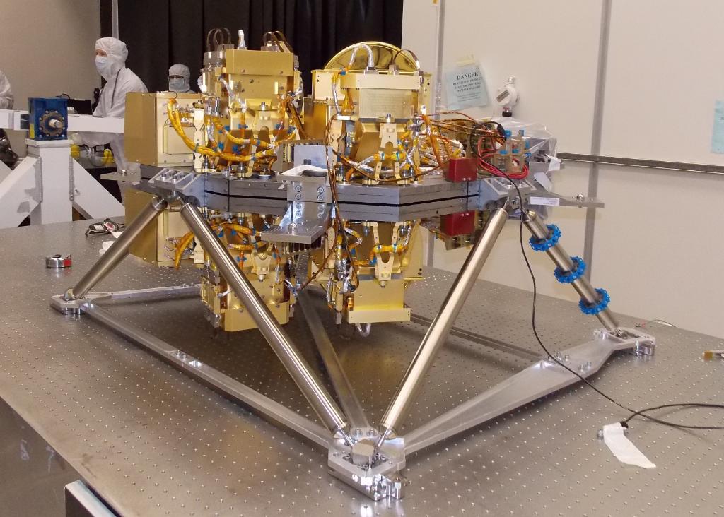 The Webb telescope's NIRCam instrument, surrounded by cleanroom engineers and technicians.