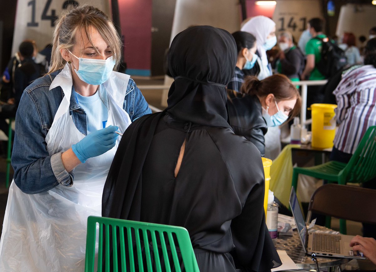 Woman vaccinates a person with the covid-19 vaccine