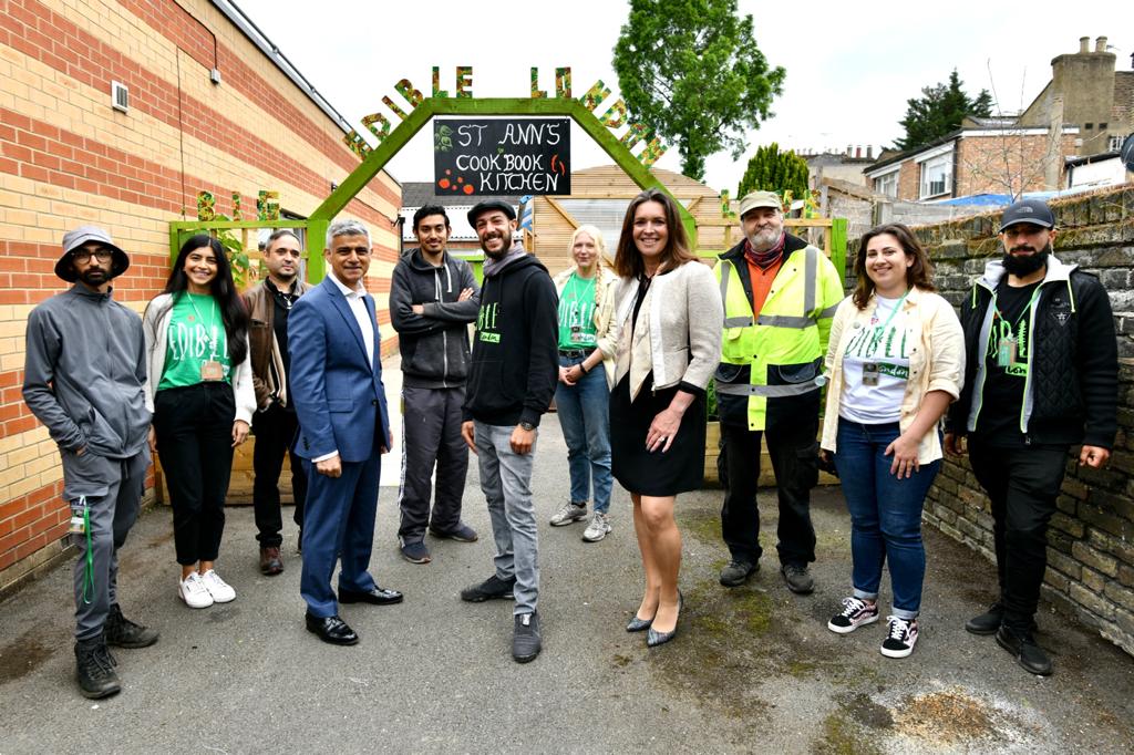 Group photo of Mayor of London, Sadiq Khan with staff and volunteers at Haringey Council's Cookbook Edible Library project. 