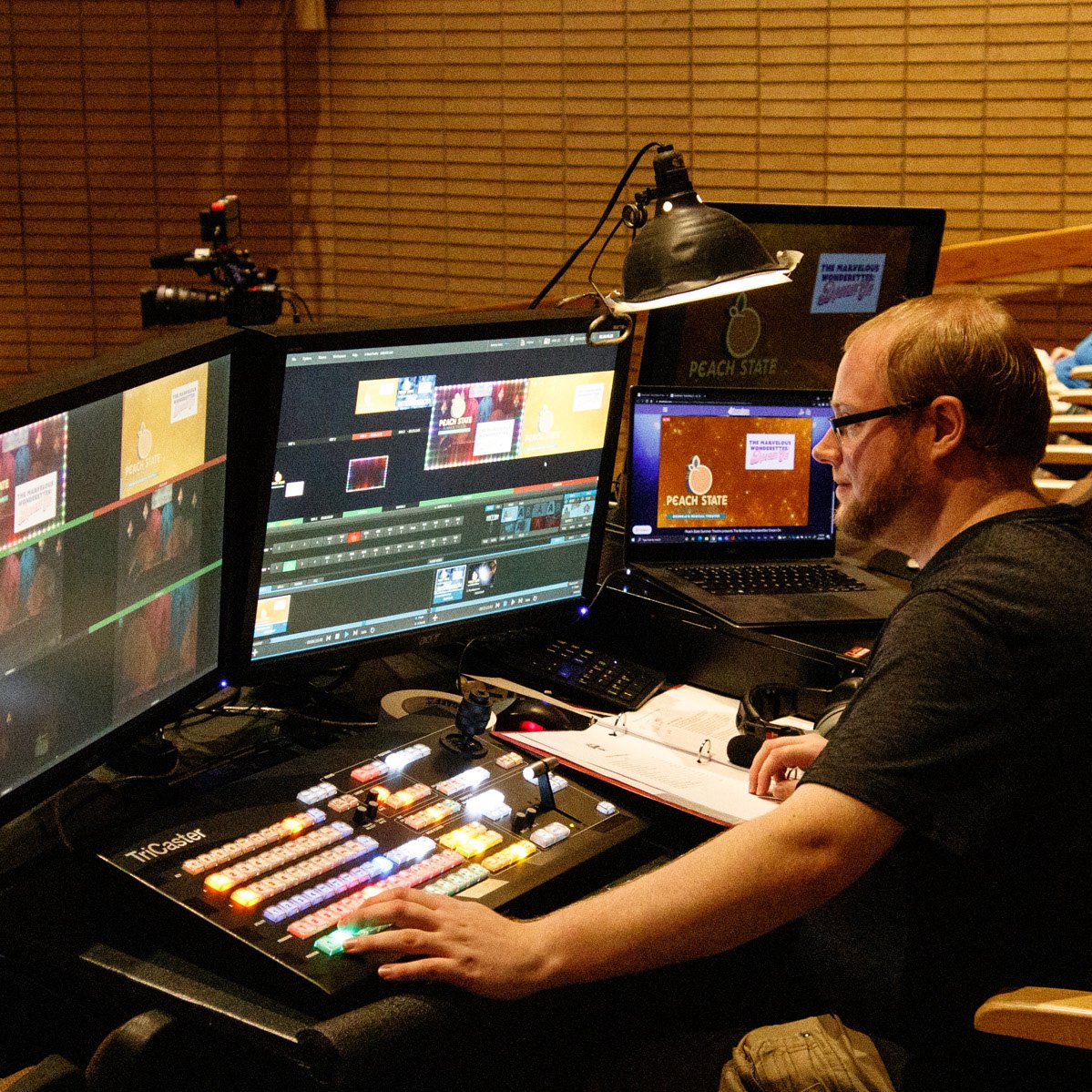 PSSTGA's tweet image. PSST Fans: How did we do it? There were 4 video cameras in the seating area and a video production switcher. 
Faculty members in the Dept of Communications Arts in these photographs: Dorrian Baber (video camera) and Andrew Black (video production switcher). 

#psstga #psstga21
